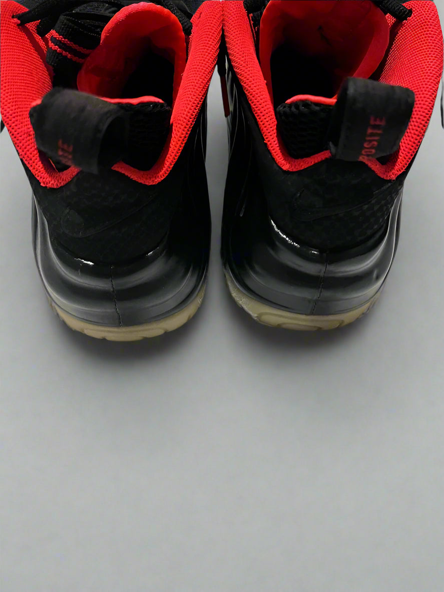 Black and red sneakers on a white surface