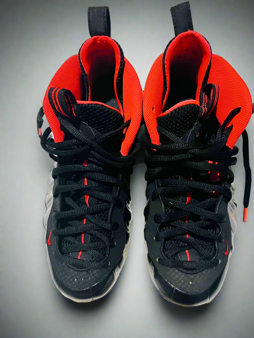 Black and red high-top sneakers on a white background
